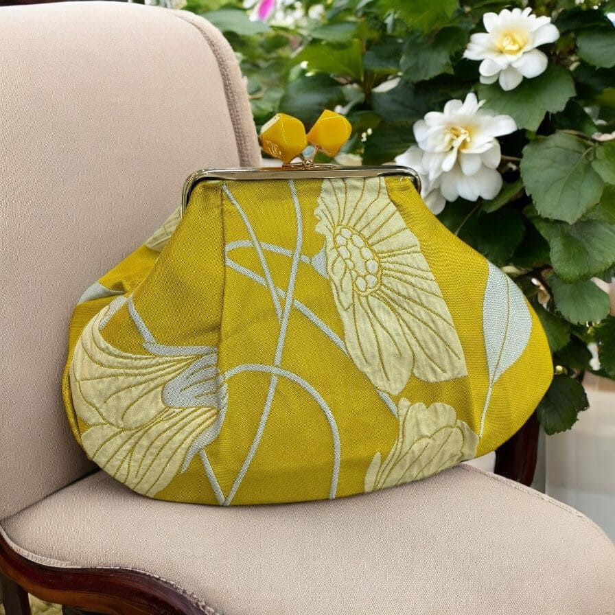 Borsa clutch in jacquard gialla con fiori